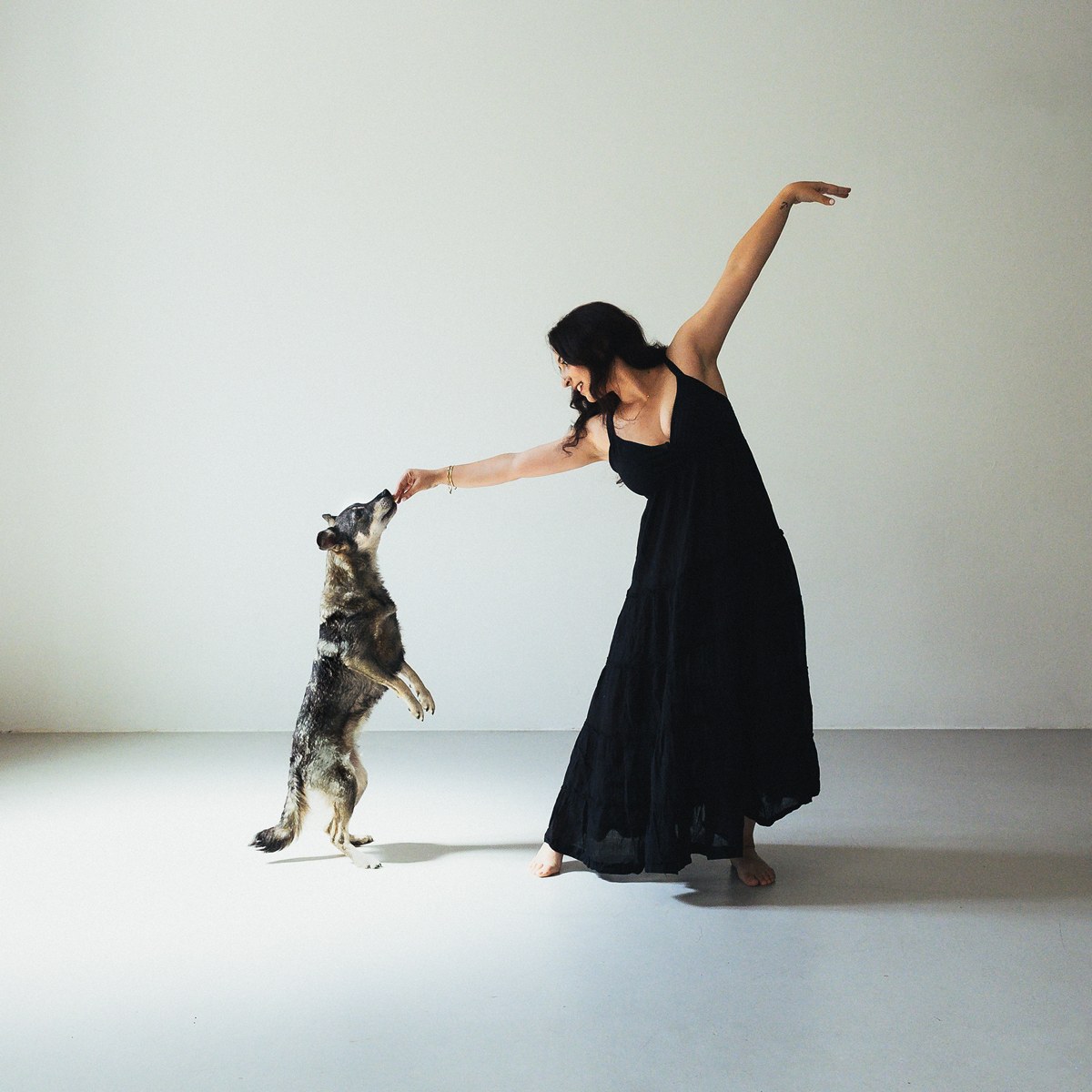 Little Wolf Waltz cover: a woman in a black dress dancing with a dog